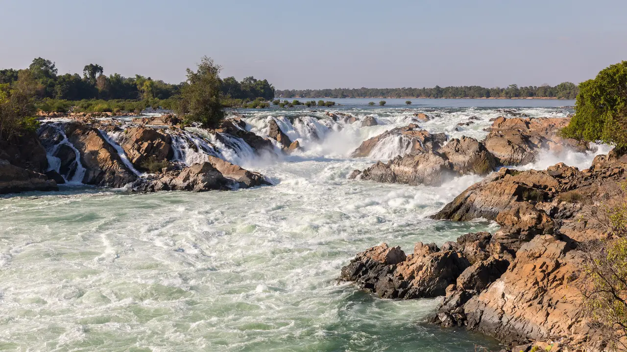 White water of the Mekong pouring over broad rocky ledges at Khone Phapheng falls